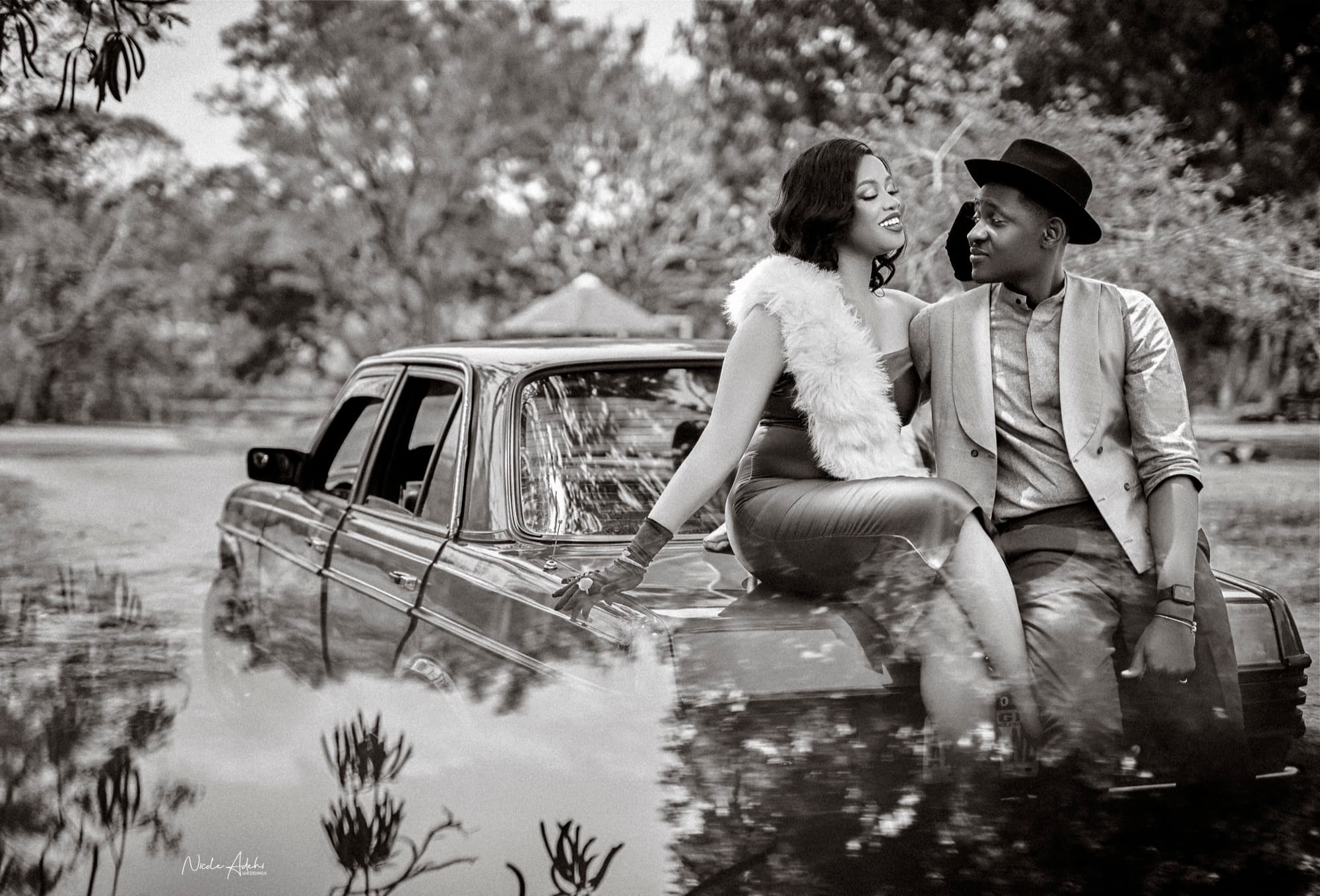 Kechi and Lanre in an editorial pre-wedding portrait on a vintage car.