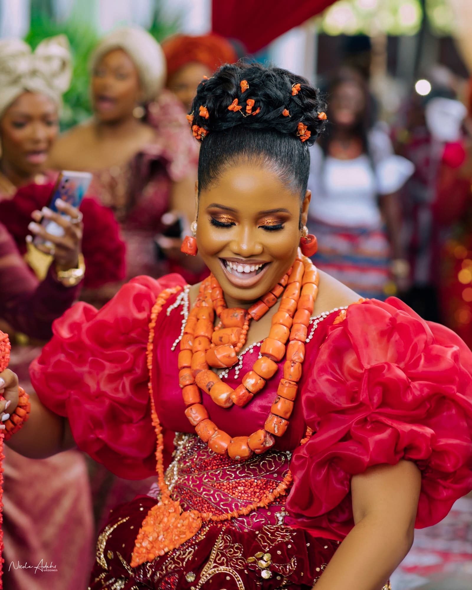 Kechi in coral beads and red aso-oke at the traditional ceremony.