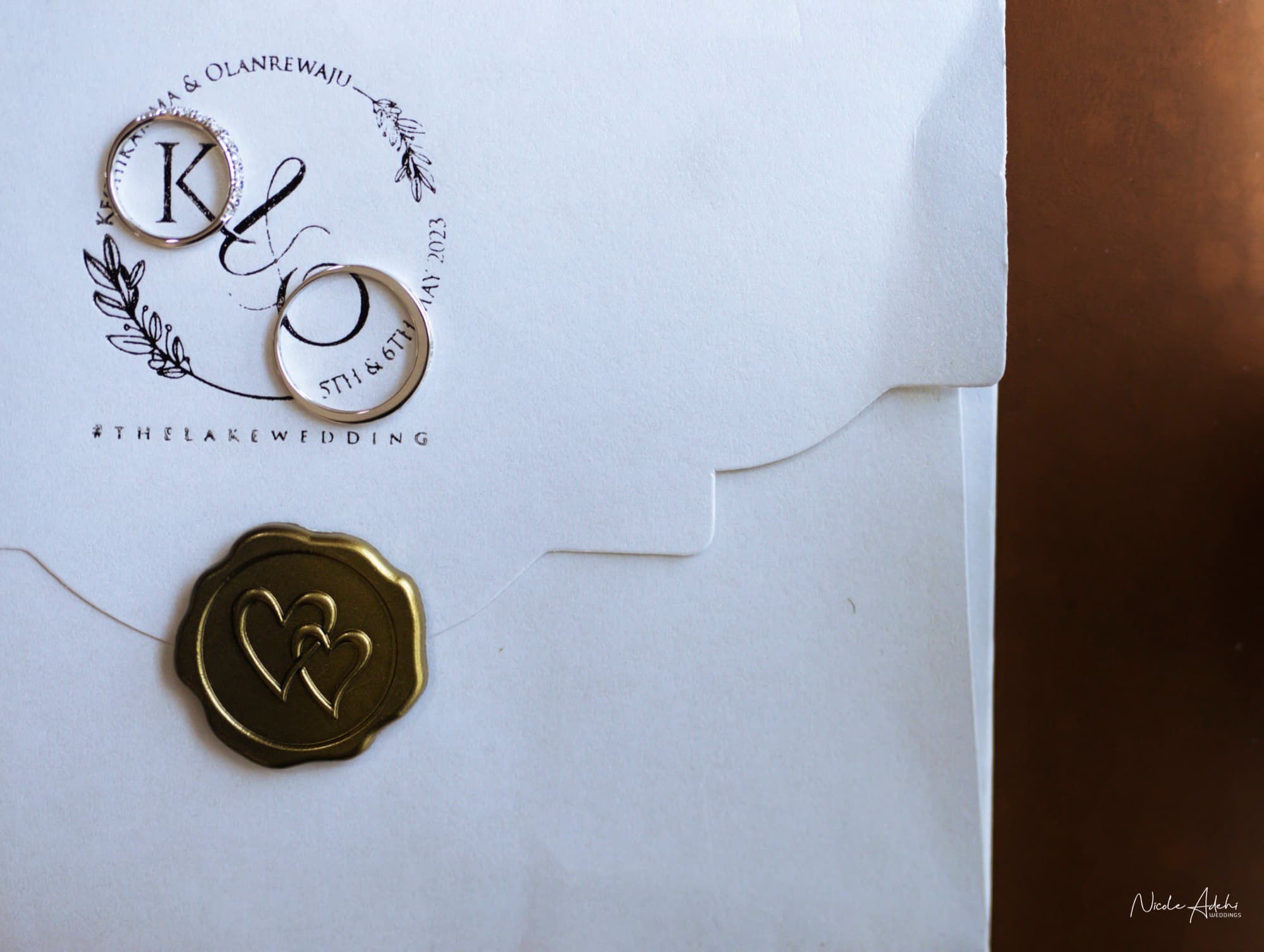 The rings on the invitation, with the couple's wax seal.