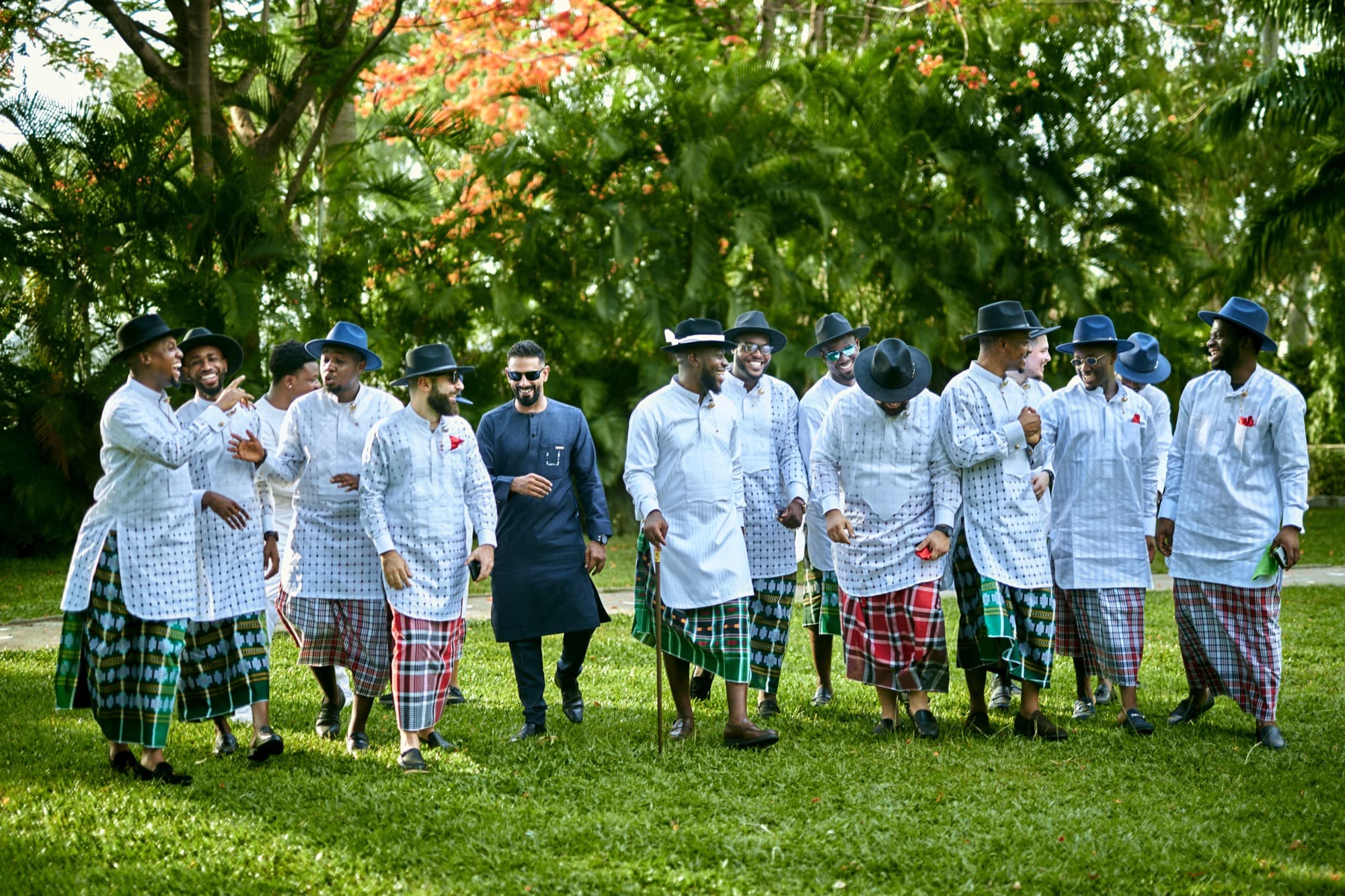 Damiete walks across the lawn with his groomsmen in coordinated Niger Delta wrappers.